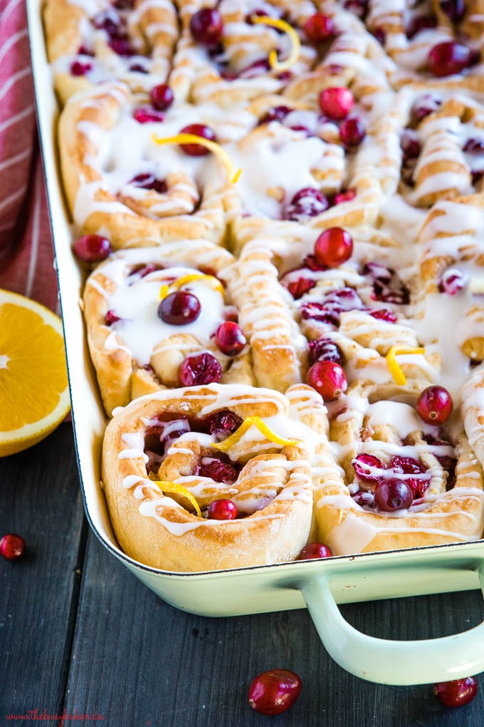 cranberry orange sweet rolls in green enamelled pan