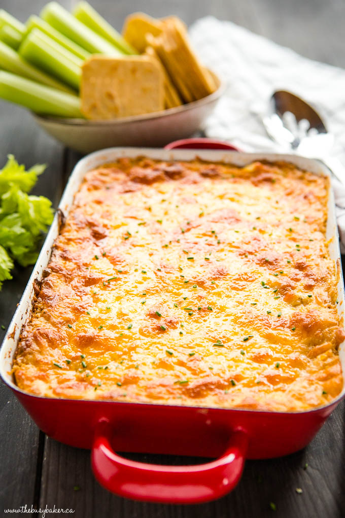 creamy, warm baked buffalo chicken ranch dip in red baking dish