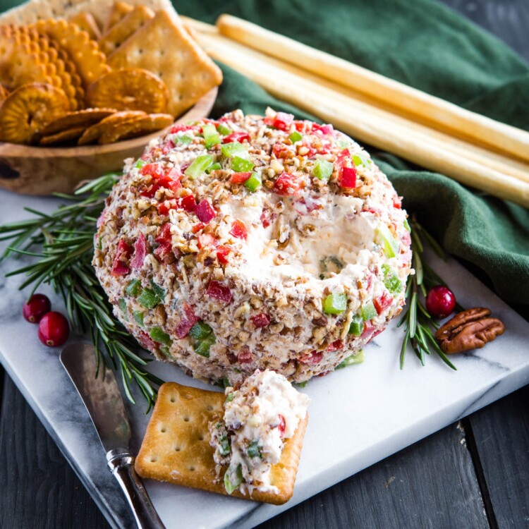 Holiday cheddar cheese ball recipe on cheese board