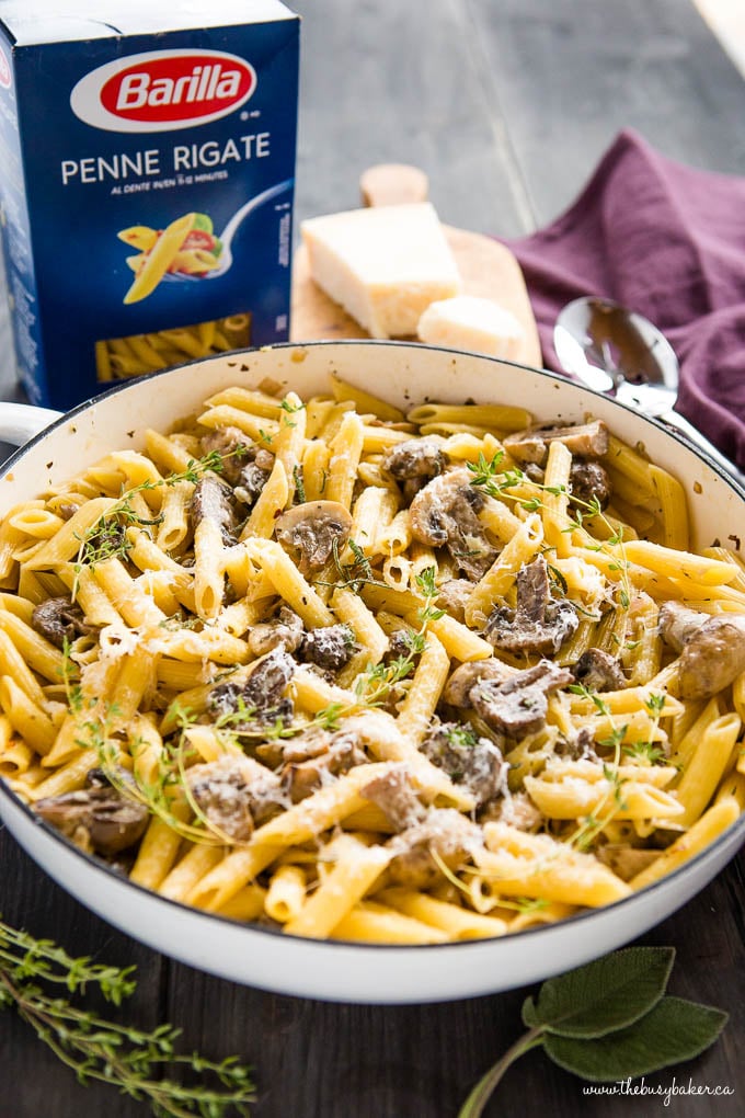 creamy mushroom champagne pasta in white pan with parmesan