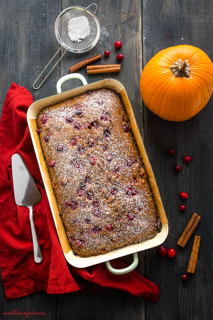 easy pumpkin cranberry cake with cinnamon sticks and powdered sugar