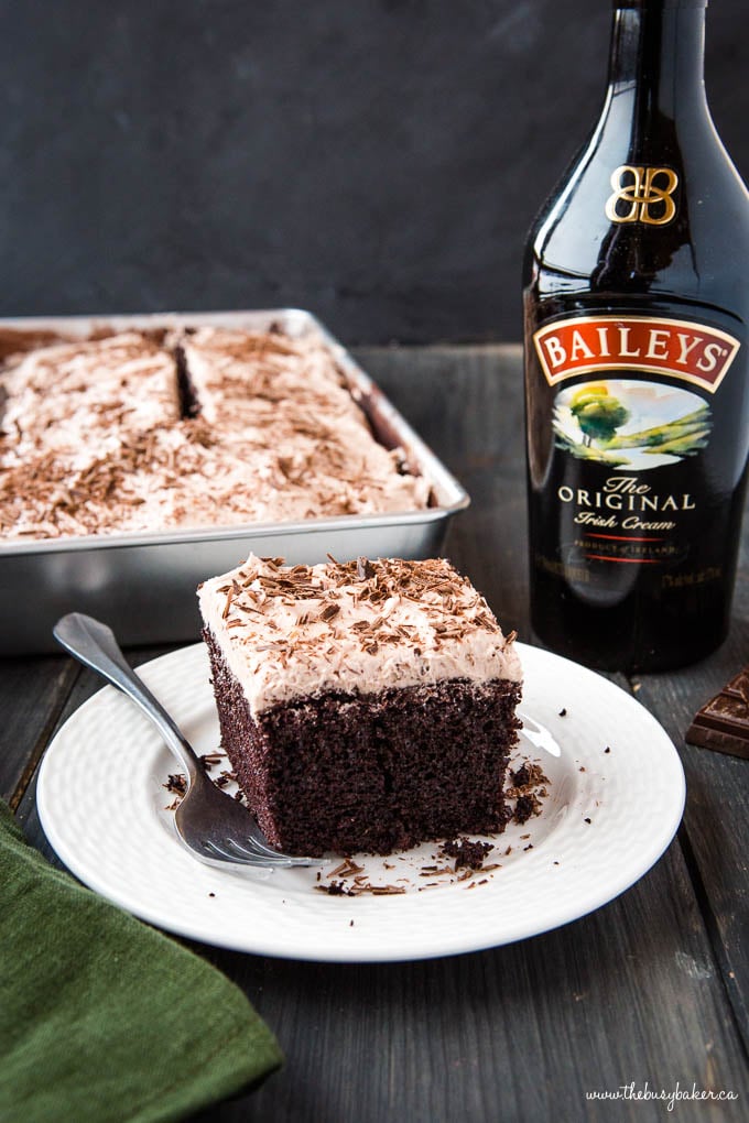 bottle of Irish Cream next to slice of Chocolate Snack Cake with Bailey's Frosting