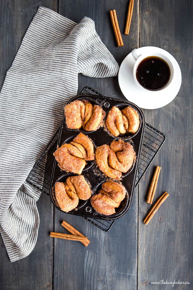 homemade breakfast pastries rolled in cinnamon sugar on wire cooling rack