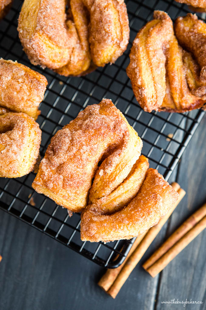 cinnamon twist donuts (breakfast pastries) on wire cooling rack