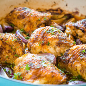 pieces of African chicken harissa in a roasting pan