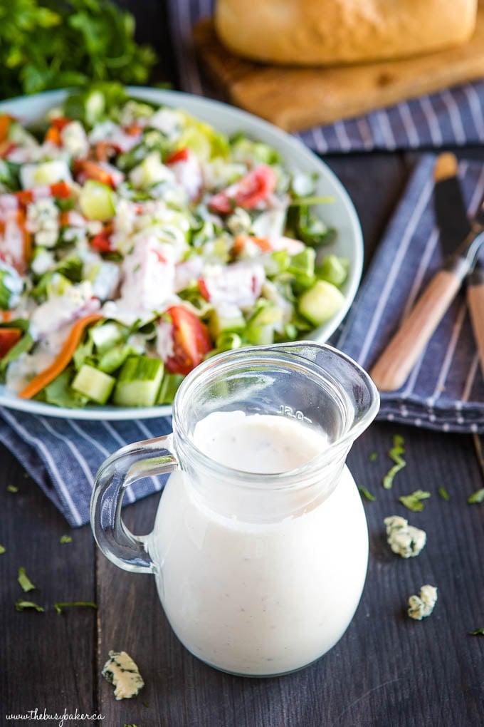 garden salad with dressing and loaf of crusty bread