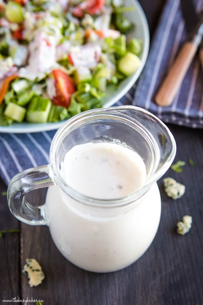 overhead image of white salad dre3ssing in glass pitcher