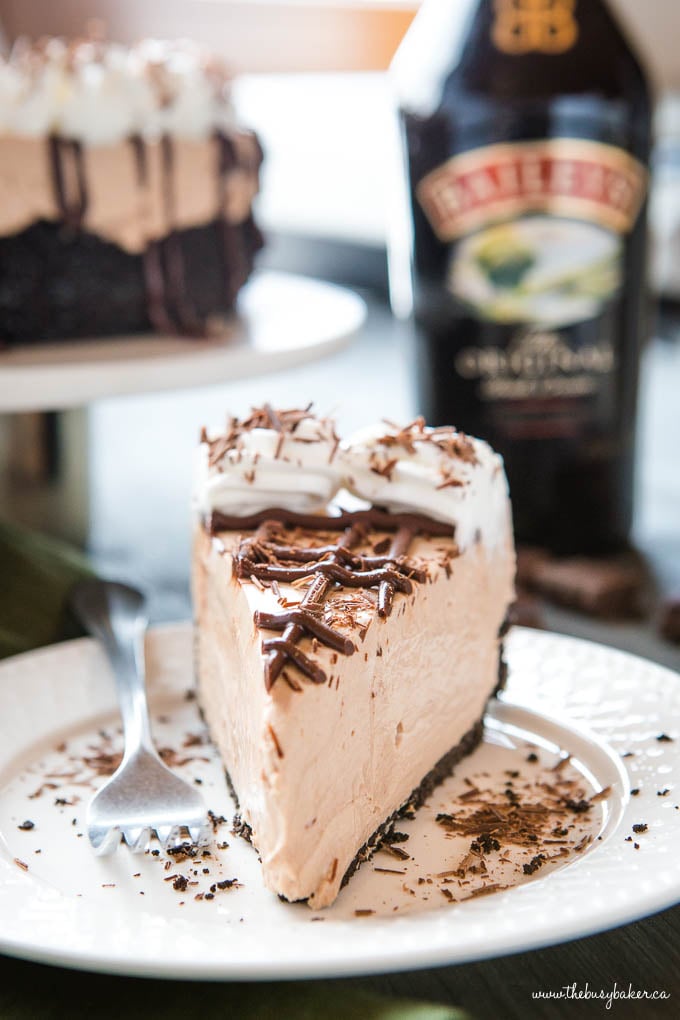 slice of Bailey's No Bake Cheesecake with chocolate and whipped cream