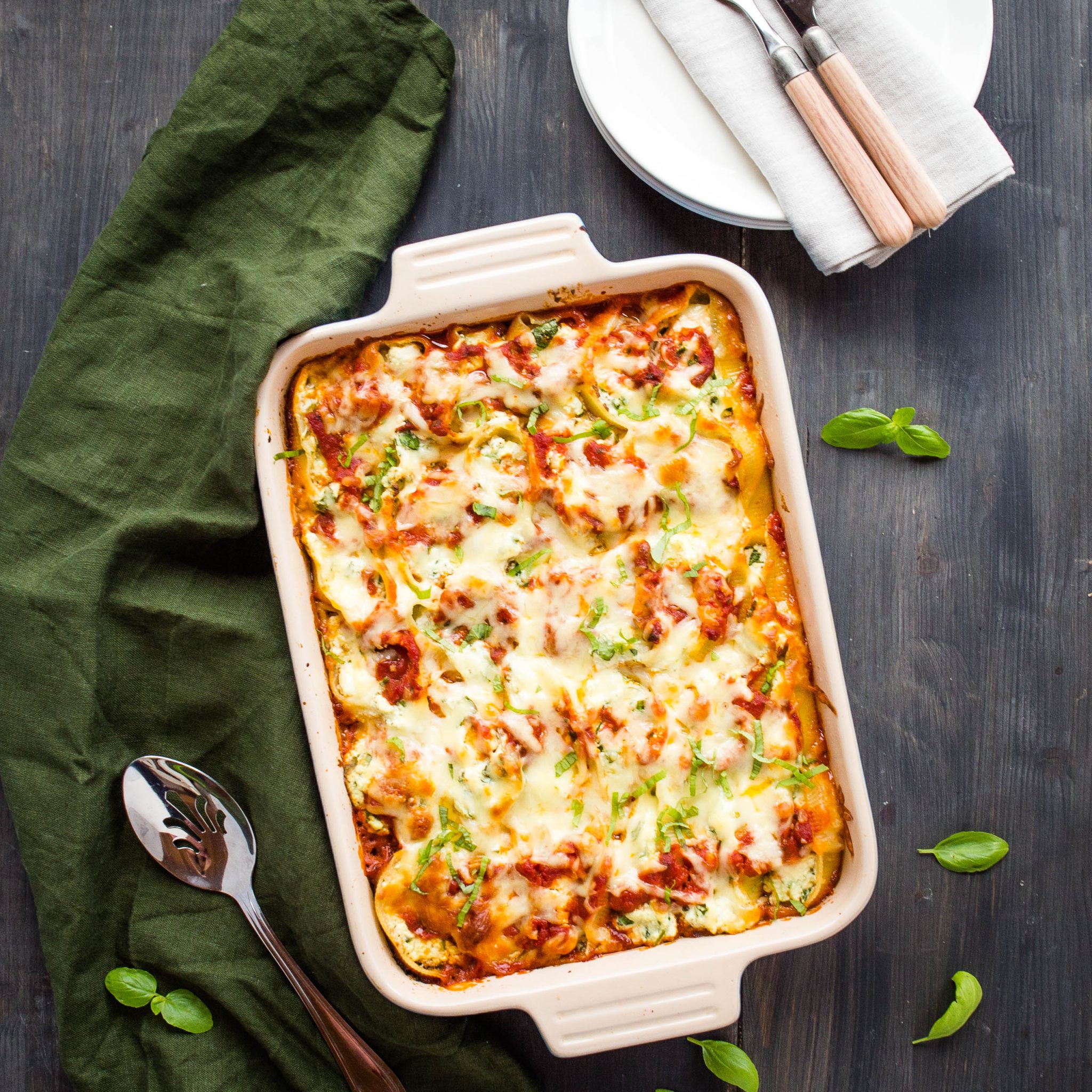casserole dish of stuffed shells with spinach, ricotta cheese, and fresh