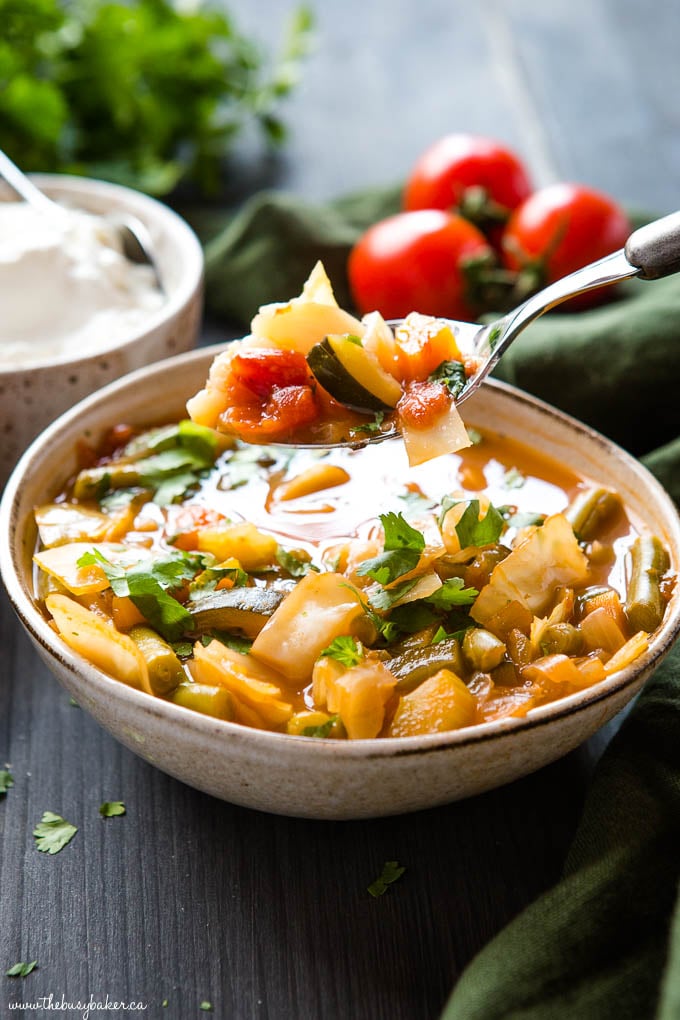 spoonful of healthy vegetable soup over the bowl