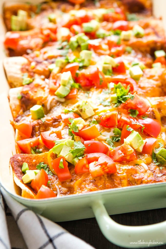 Vegetarian enchiladas in green casserole dish