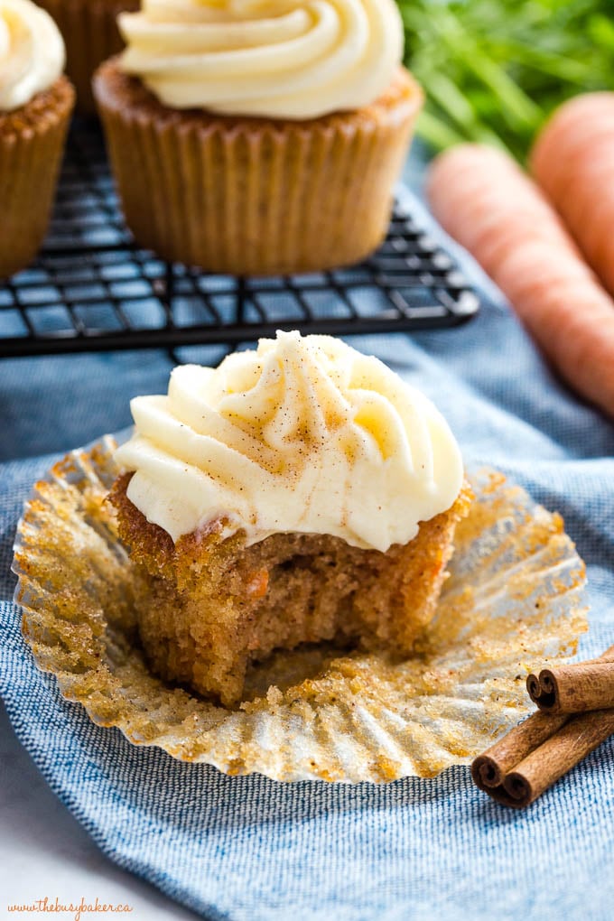 bite out of a carrot cake cupcake with cream cheese frosting