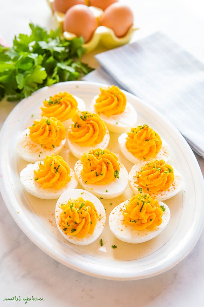 deviled eggs with chives on a platter