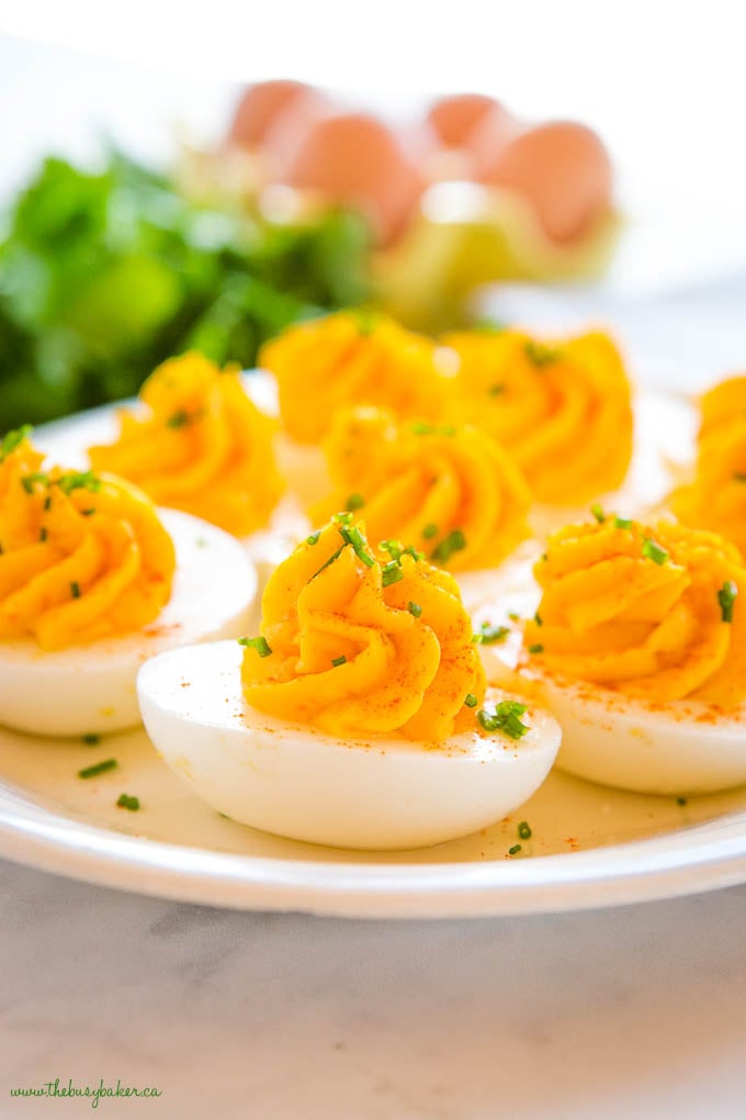 platter of easy deviled eggs garnished with chives, made with the best deviled eggs recipe