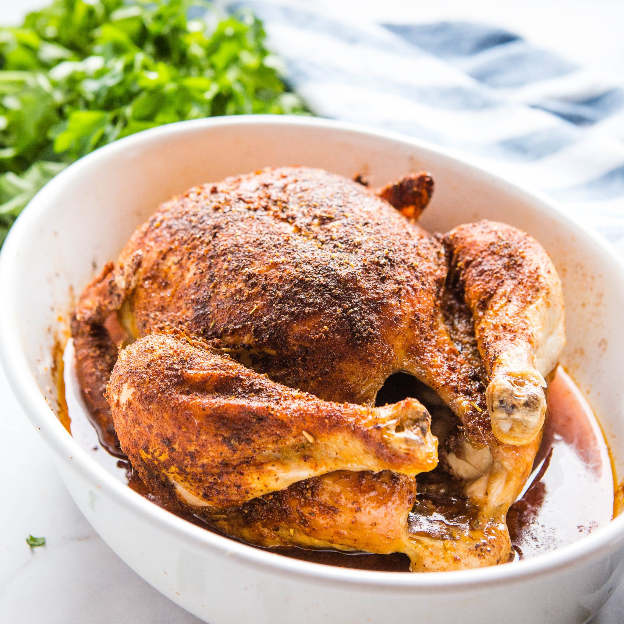 homemade rotisserie chicken in white serving dish