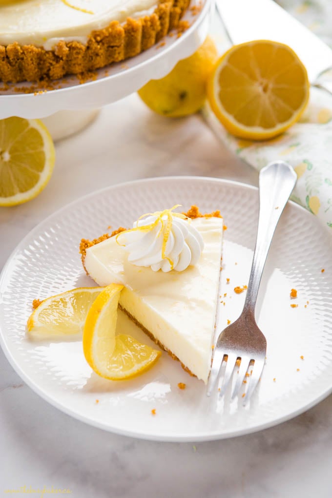 slice of citrus dessert on white plate with fork