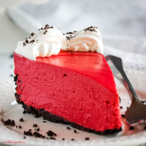 slice of no bake red velvet cheesecake with chocolate cookie crust