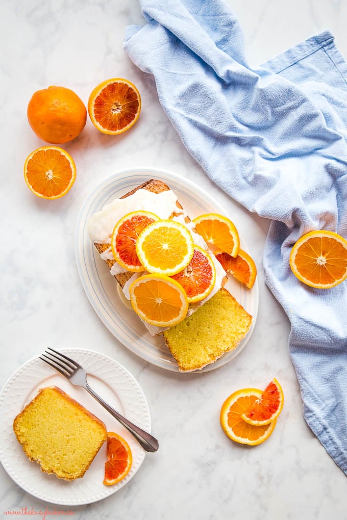 overhead image of orange glazed pound cake surrounded by fresh citrus fruit slices