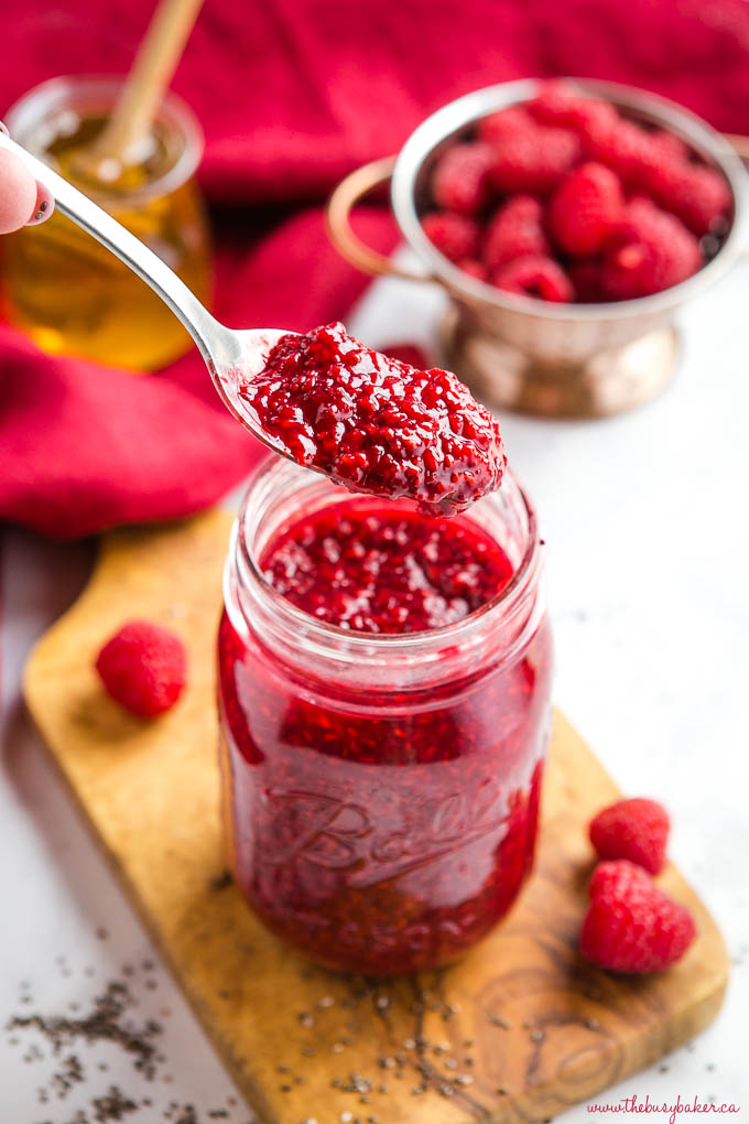 spoonful of chia seed raspberry jam with honey and fresh raspberries