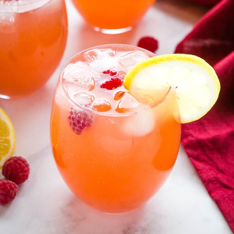 fruity punch with ice in a clear glass pitcher