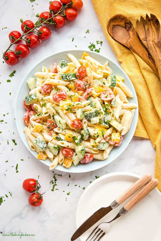 pasta salad in blue bowl with cherry tomatoes