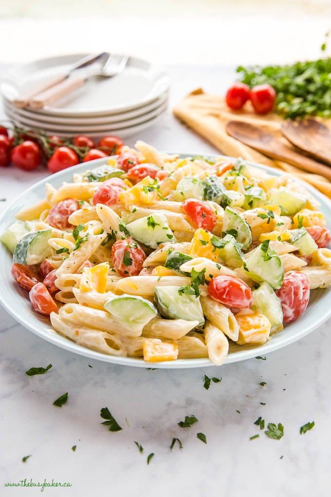 bowl of pasta salad with veggies and fresh herbs