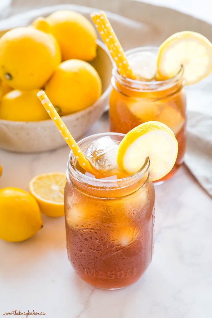 iced tea in mason jar with lemon slice and yellow straw