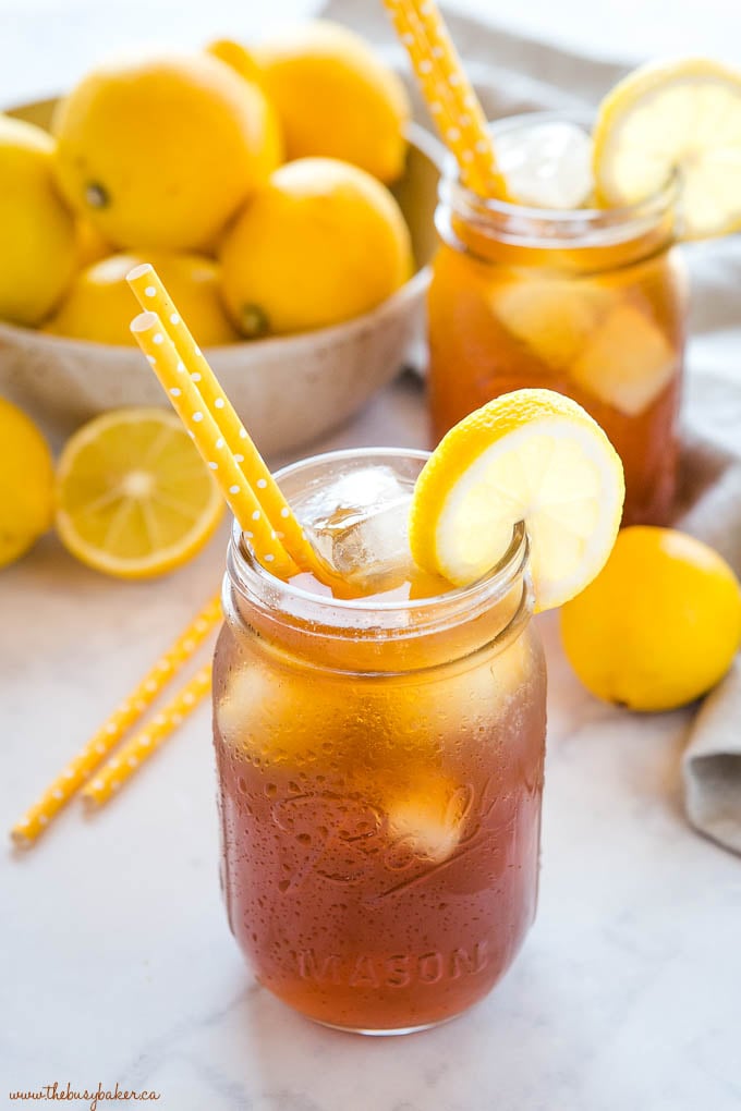 iced tea in mason jars with ice and lemon slices