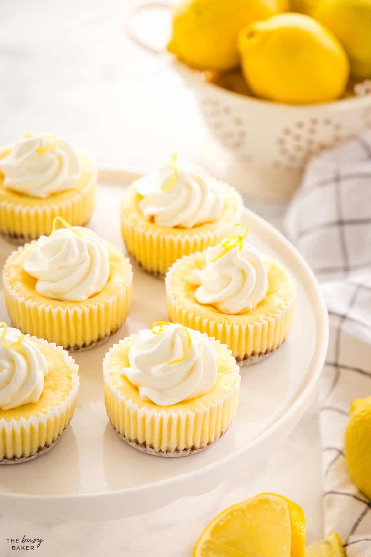 mini lemon cheesecakes with whipped cream and lemon zest