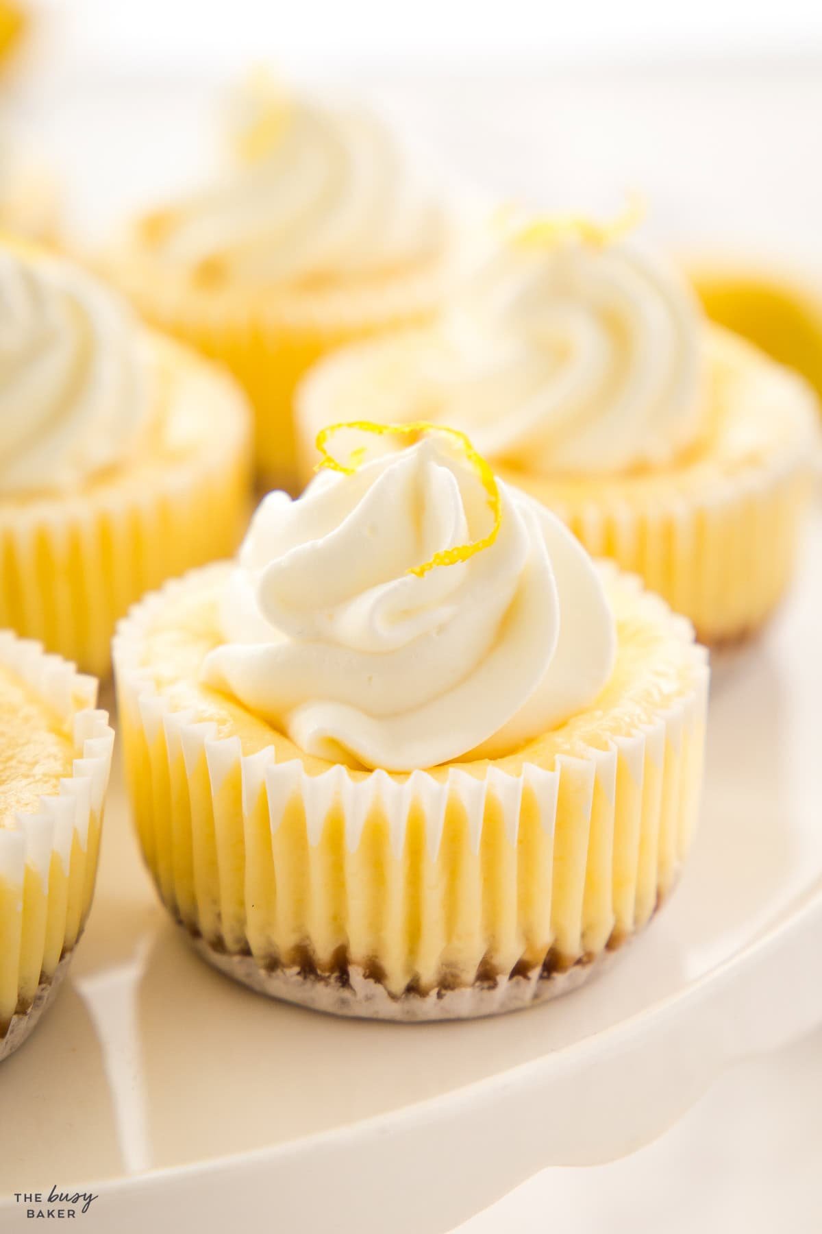 mini lemon cheesecakes on a cake stand
