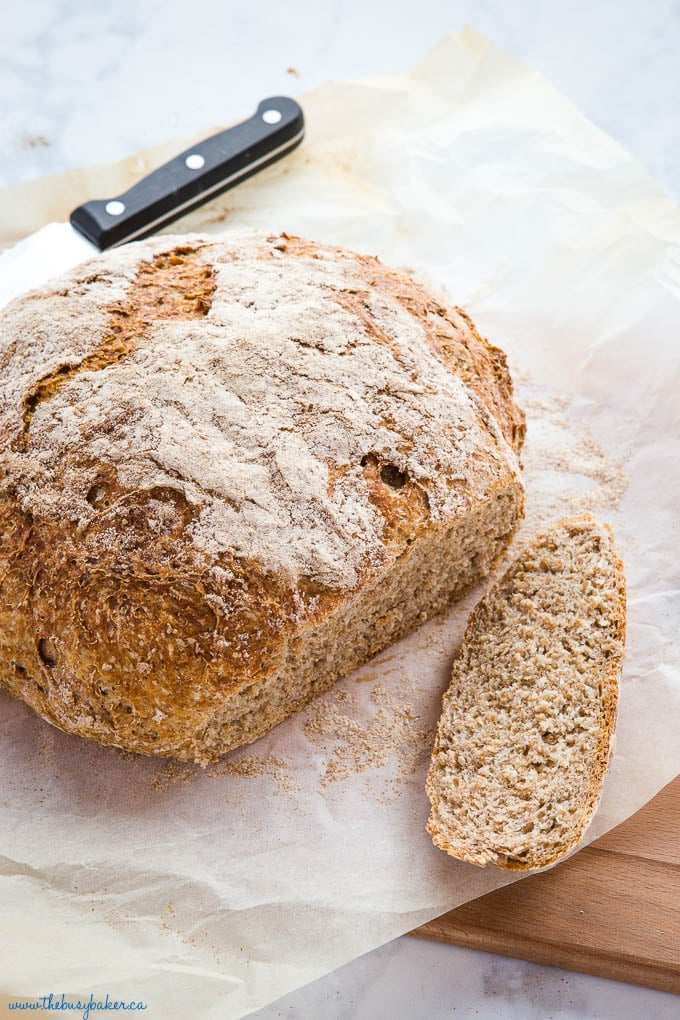 slice of whole wheat bread next to remainder of round loaf