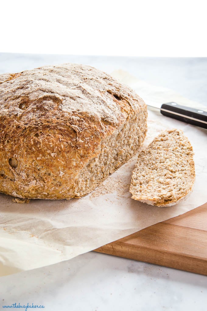 fresh loaf of homemade wheat bread with end slice removed