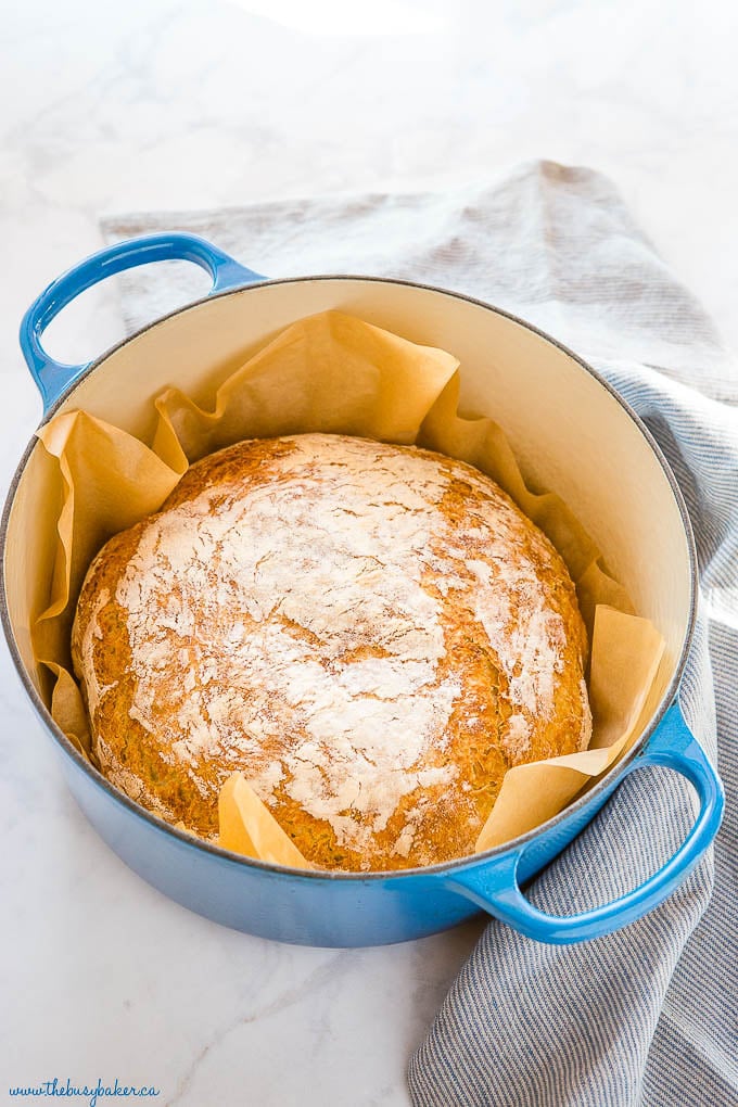 quick no knead bread baked in a large blue stock pot lined with parchment paper