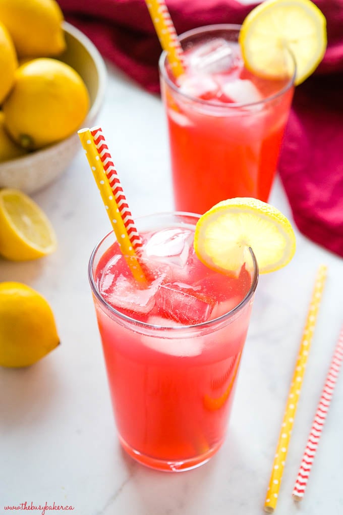 overhead photo looking down on glasses of pink lemonade with ice and lemon slices