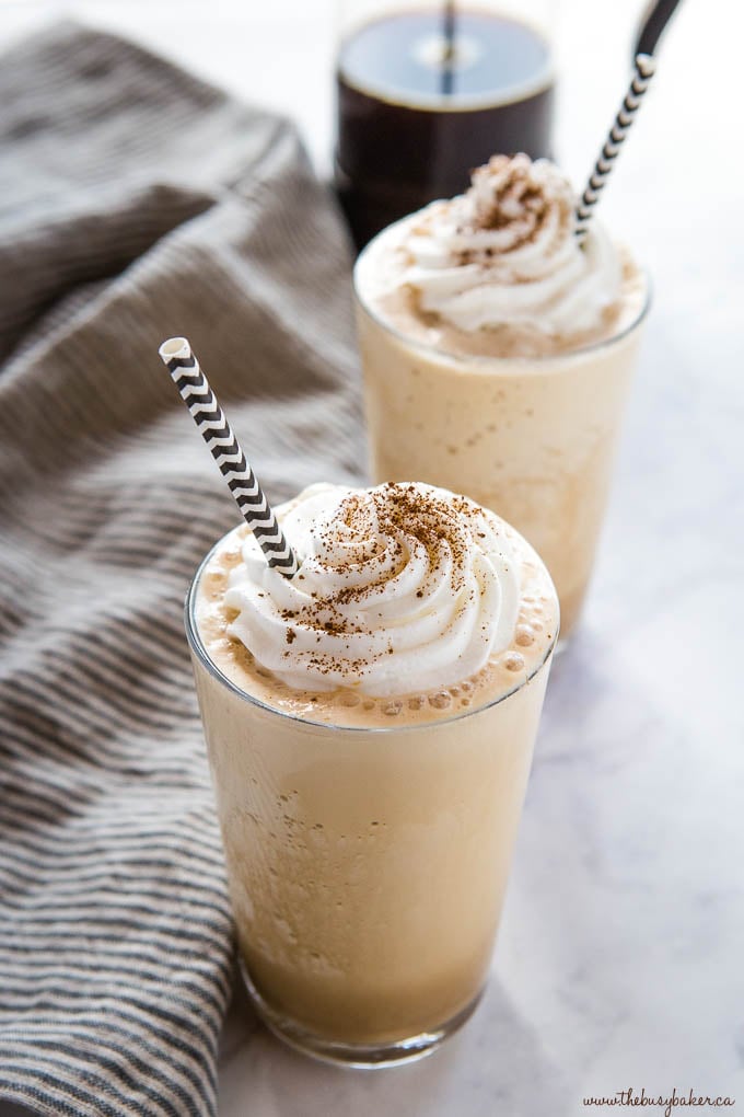 2 homemade frappuccinos with whipped cream and paper straws