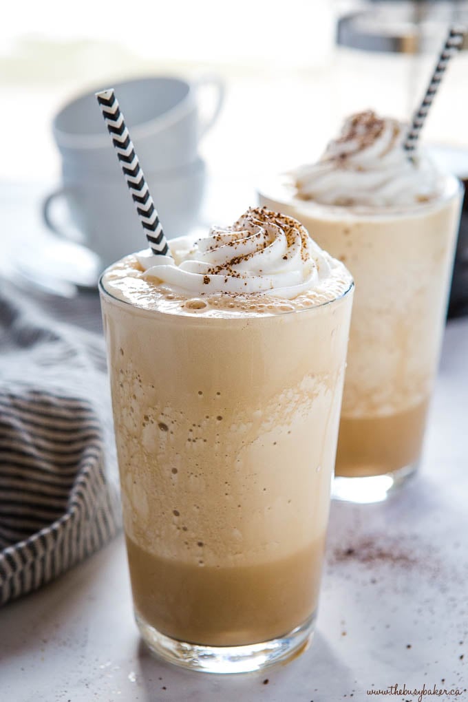 healthy homemade frappuccinos with whipped cream and black and white paper straws