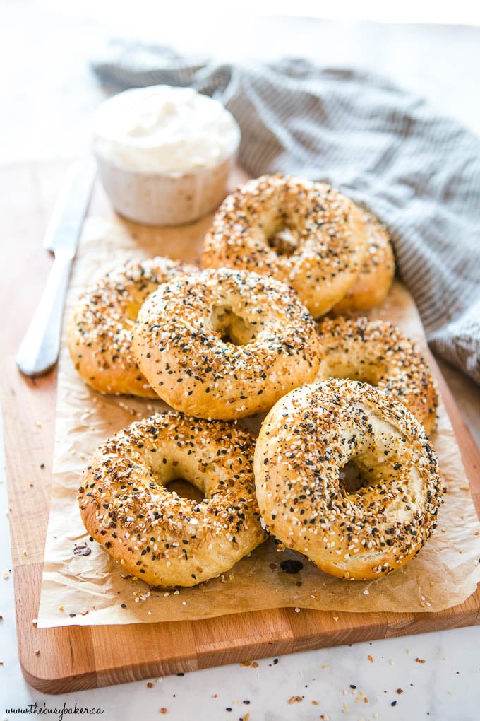 everything bagels on wooden board with cream cheese
