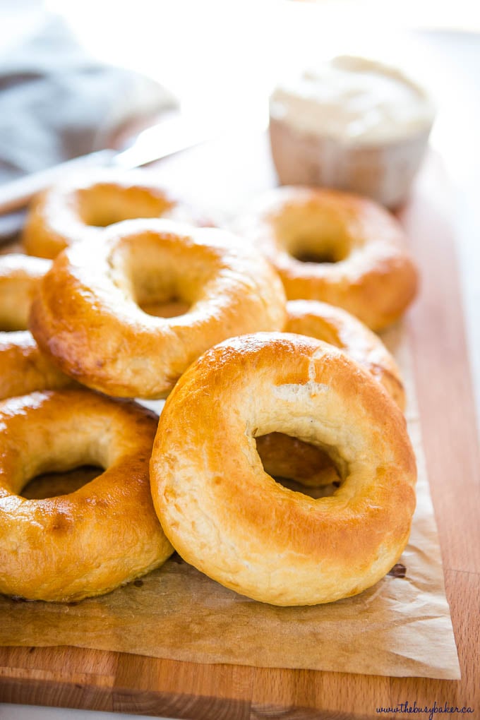 homemade new york-style bagels on wooden cutting board 