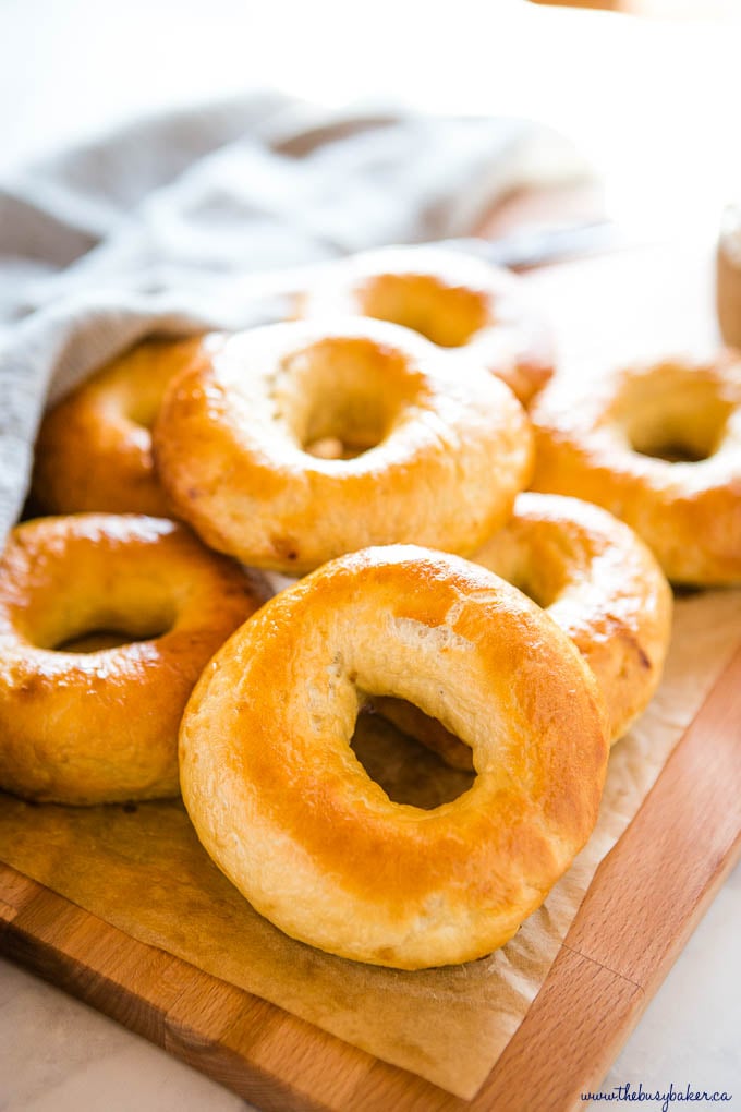 homemade golden brown new york bagels on wooden cutting board