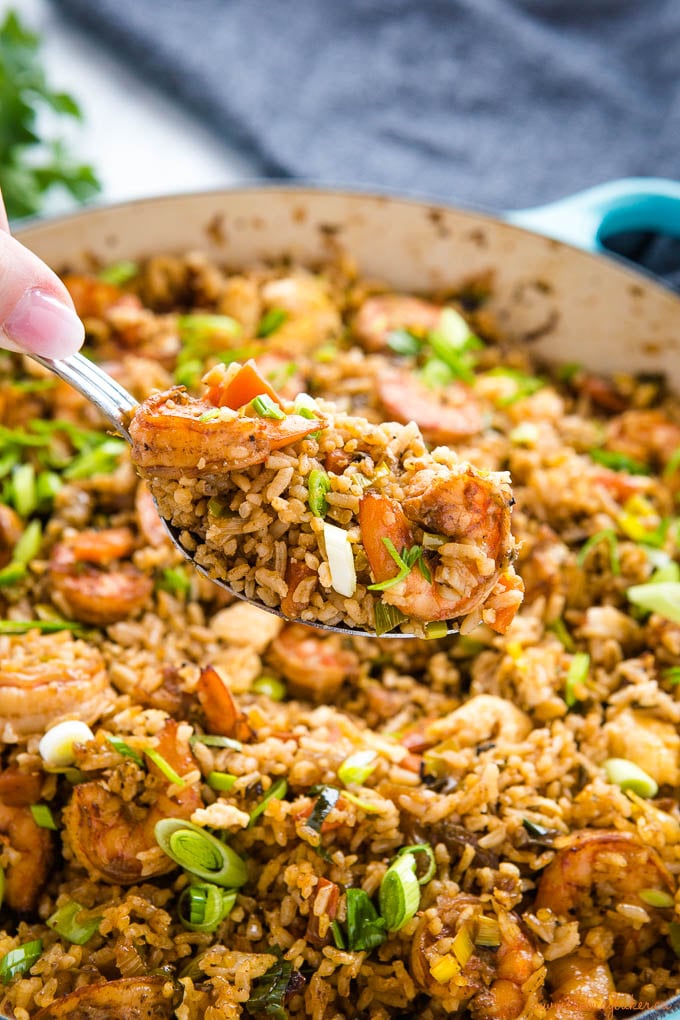 spoonful of shrimp fried rice over cast iron pan