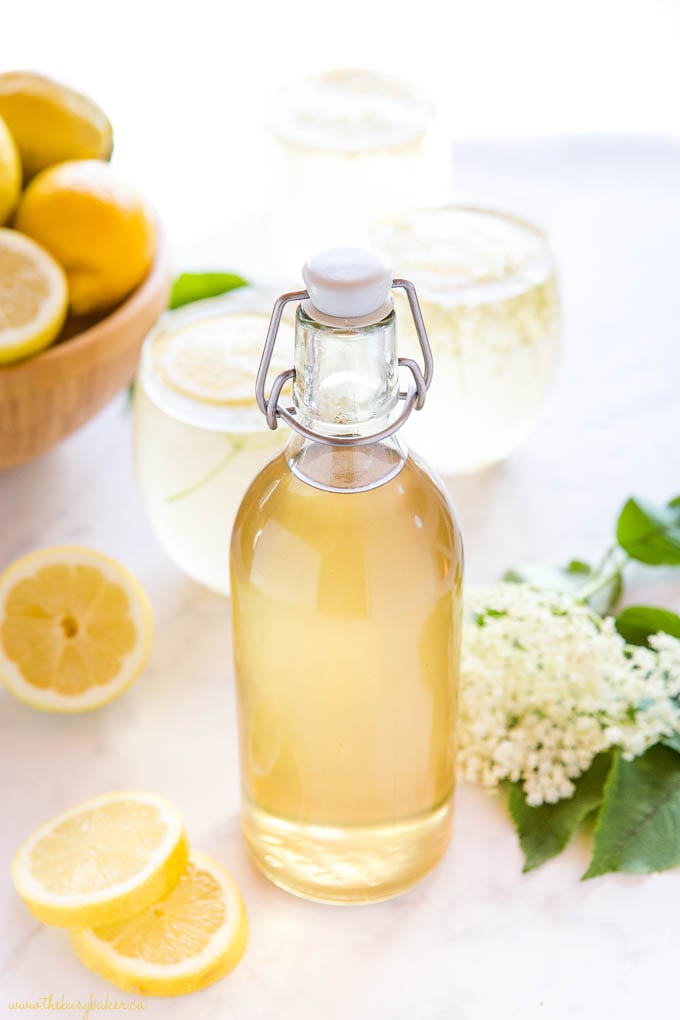 tall glass bottle of homemade elderflower syrup