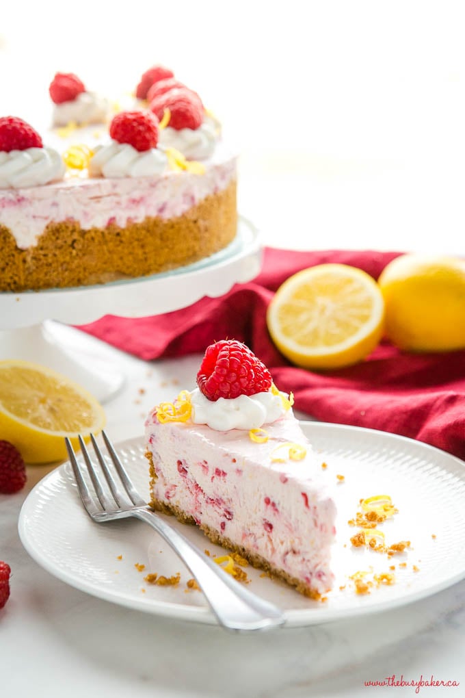 slice of lemon raspberry no bake cheesecake on white plate with fork