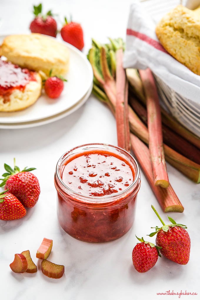 jar of strawberry rhubarb jam with fresh rhubarb and strawberries