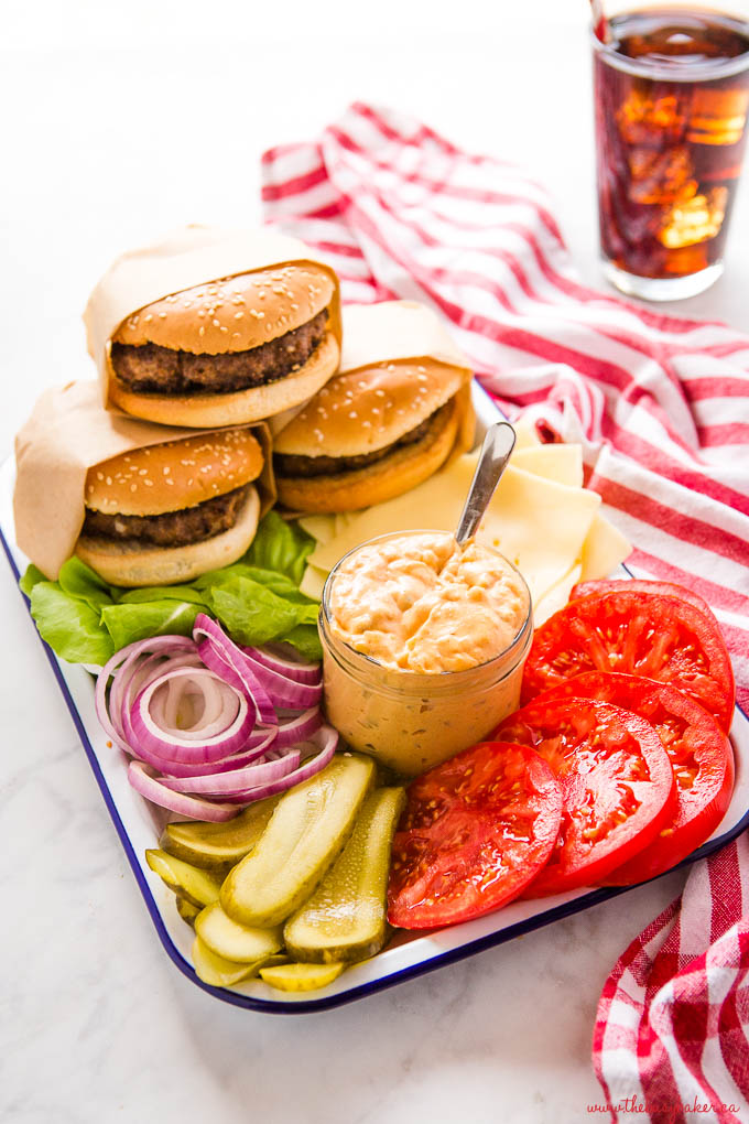 white enamel platter with burger fixings and 3 homemade burgers