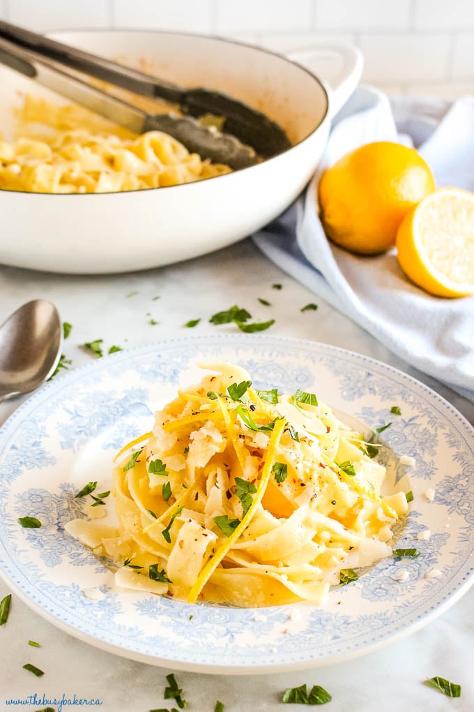 pasta al limone on vintage blue plate with lemon zest and Parmesan