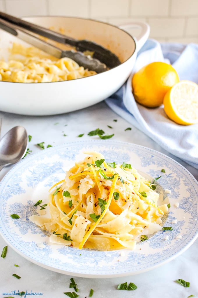 pasta al limone on vintage blue plate with fresh lemons