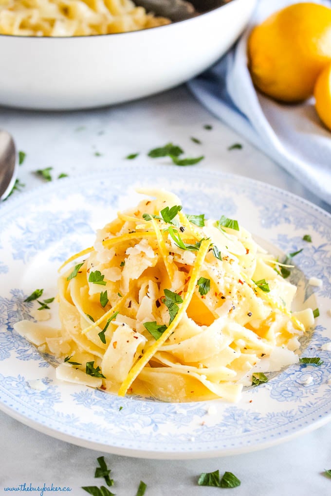pasta al limone on blue vintage plate with fresh herbs