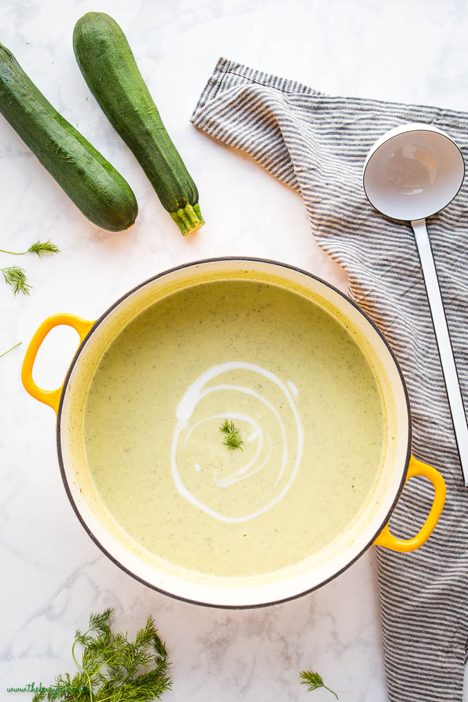 overhead image: creamy zucchini soup in yellow pot
