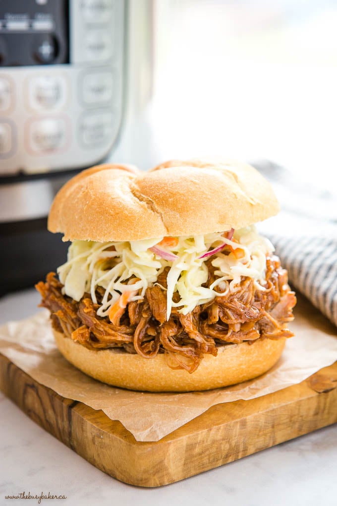 barbecue pulled pork with coleslaw on a kaiser bun