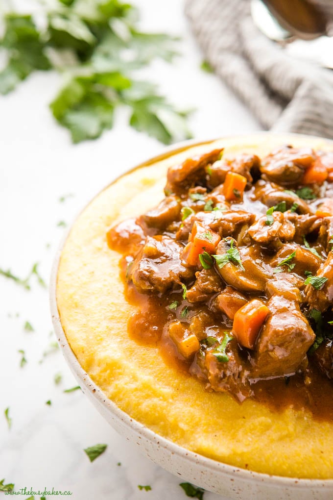 bowl of polenta with braised beef and vegetables